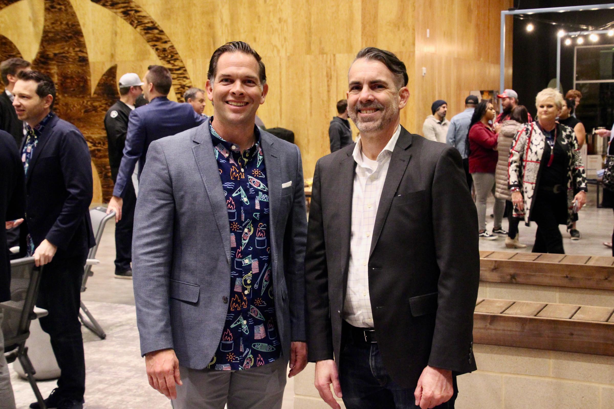 Solo Brands CEO John Merris (left) and Grapevine Economic Development Director Larry Holt (right) celebrate the company's ribbon cutting in Grapevine
