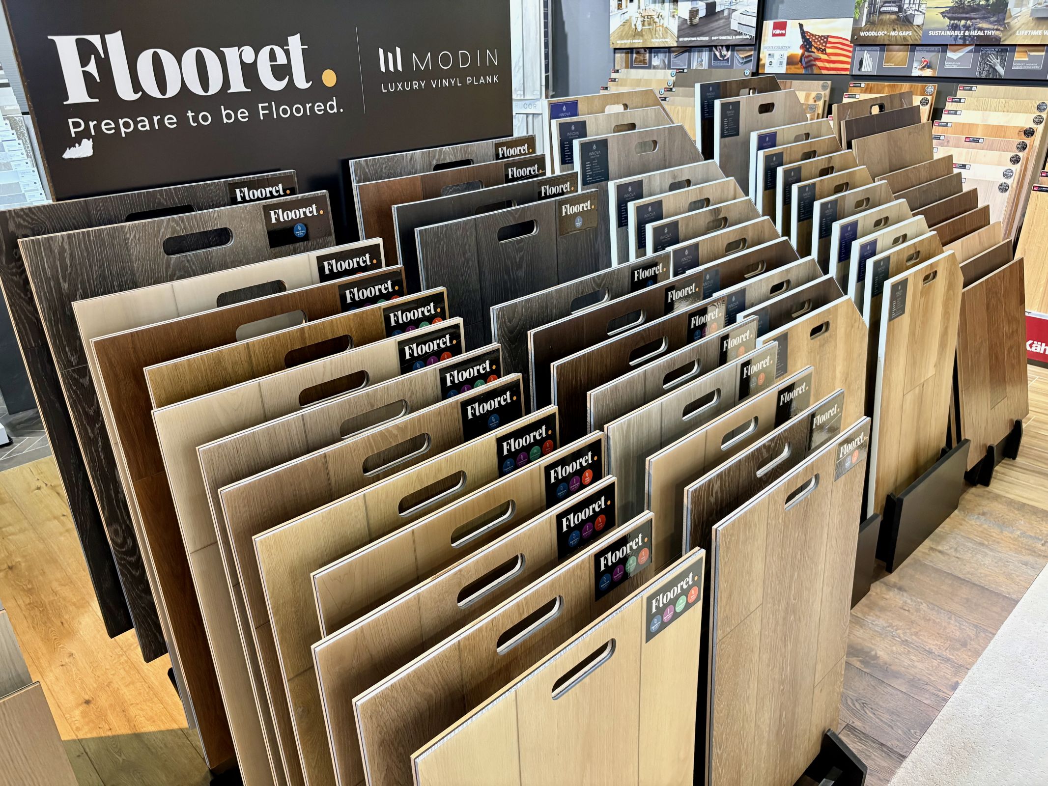 Flooring samples from the company arranged for display inside a showroom.